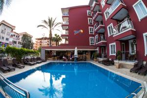 a swimming pool in front of a building at My Home Apart in Alanya