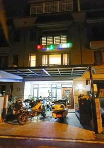a group of motorcycles parked in front of a building at 埔里包棟民宿-吉美民宿-每天只接待1組客人 in Puli