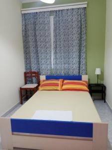 A bed or beds in a room at Monte Caputo Holiday House