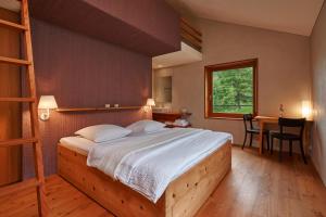 a bedroom with a bed and a desk and a table at Pension Laresch in Mathon