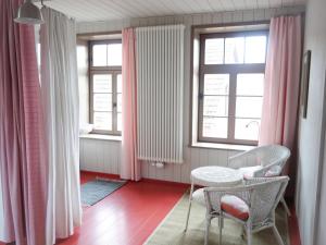a room with a table and chairs and windows at Schrot-Kontor in Tangermünde +11 photos