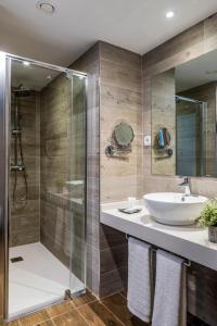 a bathroom with a sink and a shower at Suite Home Pinares in Santander
