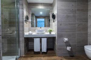 a bathroom with a sink and a shower at Suite Home Pinares in Santander
