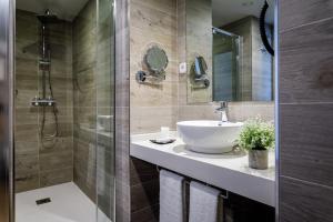 a bathroom with a sink and a shower at Suite Home Pinares in Santander