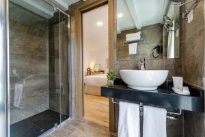 a bathroom with a sink and a shower at Suite Home Pinares in Santander