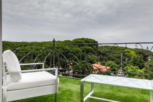 a white chair and a table on a balcony at Suite Home Pinares in Santander