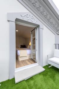 a room with a window with a bed and a couch at Suite Home Pinares in Santander