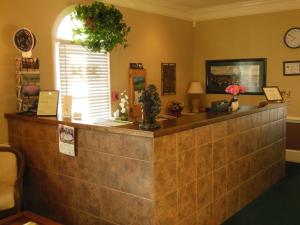 a reception counter at a hotel with areath on the wall at Beau Rivage Golf and Resort in Wilmington