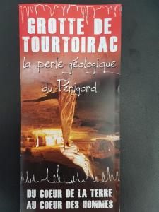 a book with a picture of a mountain at Au Périgord Noir in Hautefort