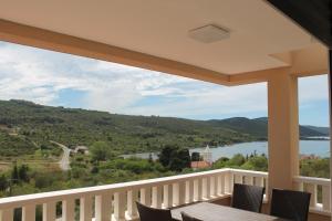 a balcony with a view of a lake and mountains at Paradise in Brbinj