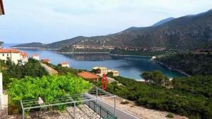 a view of a body of water with mountains at Two-storey Mansion at the Sea in rkadiko Chorio