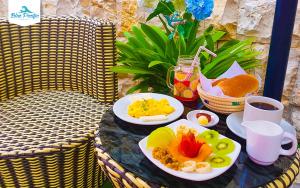 a table topped with plates of food on a table at Hostal Blue Pacific in Manta