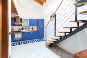 a kitchen with blue cabinets and a staircase at Stella Marina 1 in Venice