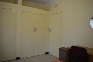 a room with two white cabinets and a window at Kasuda House - Rent the entire house in Lusaka