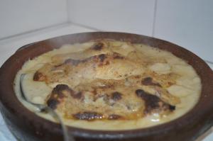 a pan filled with food on a stove at Sofra E Shpatit in Elbasan