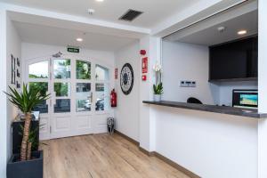 a living room with white walls and a counter at Suite Home Pinares in Santander