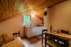a kitchen with a table and a sink in a room at Apartments Sopot in Risan