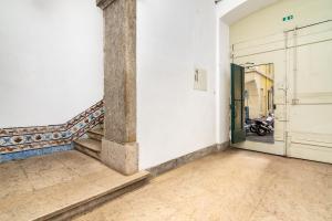 una habitación vacía con una escalera y una puerta con una motocicleta en Lisbon Downtown Luxury Family Residence, en Lisboa