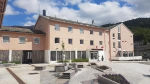 a large building with benches in front of it at Glomfjord Hotel in Glomfjord