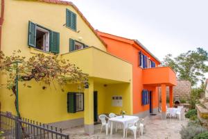 a building with tables and chairs in front of it at Casa Limone in Belej