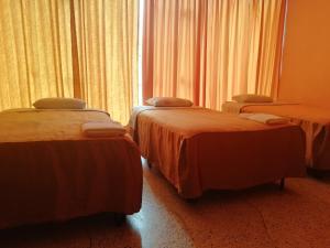 Postel nebo postele na pokoji v ubytování Hospedaje Oasis + 9 fotografií