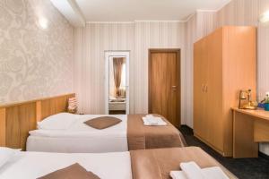 Postel nebo postele na pokoji v ubytování Hotel Central Point