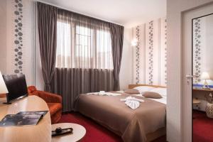 Postel nebo postele na pokoji v ubytování Hotel Central Point