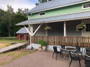une terrasse avec des tables et des chaises en face d'une maison dans l'établissement Nalles Gästhem, à Eckerö