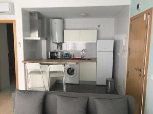 a kitchen with white cabinets and a counter top at Calle Ollerias in Málaga