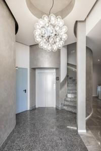 a large lobby with a chandelier and stairs at Lake Como Golf Hotel in Como