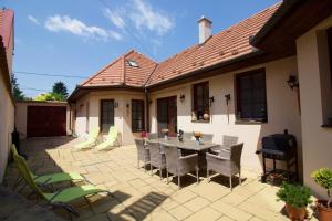 a patio with a table and chairs in front of a house at Leo Vendeghaz in Eger