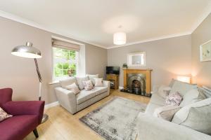 a living room with two couches and a fireplace at Seal Cottage in Hexham