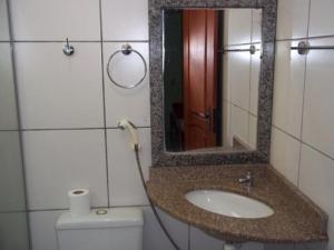 a bathroom with a sink and a mirror and a toilet at Epílogo Palace Hotel in Rio Branco +23 photos