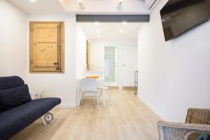 a living room with a couch and a table at BcnStop Sagrada Familia in Barcelona