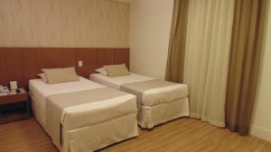 Voodi või voodid majutusasutuse Mirasol Copacabana Hotel toas