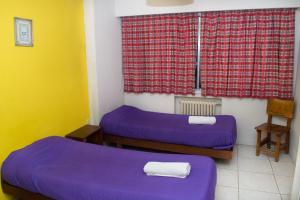 Postel nebo postele na pokoji v ubytování Marcopolo Inn Hostel Bariloche