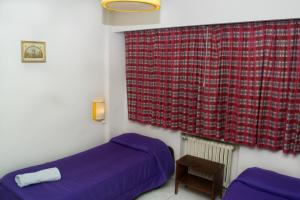 Postel nebo postele na pokoji v ubytování Marcopolo Inn Hostel Bariloche