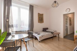 a living room with a bed and a table and chairs at OA - Apartament 50m od Rynku - Old Market Square in Wrocław