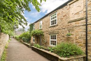 an old brick building with a pathway in front of it at Seal Cottage in Hexham