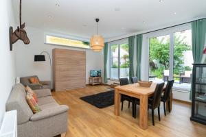 a living room with a table and a couch at Old Town Apartments in Kaufbeuren