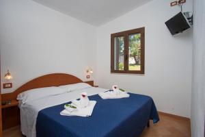 Postel nebo postele na pokoji v ubytování Cilento Dreams Village