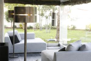 a living room with two white couches and a lamp at Hotel Boutique Ses Pitreras in San Antonio Bay