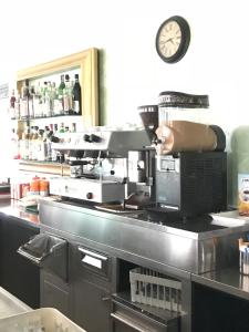 a kitchen with a coffee machine on a counter at Residence il Tombolo in Principina a Mare