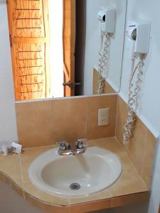 a bathroom with a sink and a mirror at Axkan Arte Hotel in San Cristóbal de Las Casas +55 photos