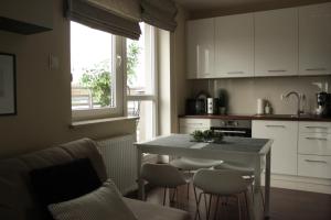 a kitchen with a table and some chairs and a counter at Sabinówek in Kielce