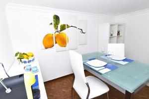 a dining room with a blue table and white chairs at La Perla Blu in Capri