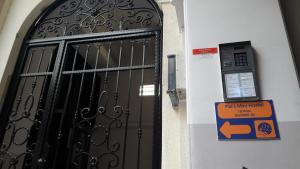 a door in a building with a sign next to it at Pal's Mini Hostel in Budapest