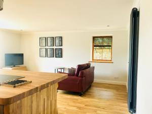 a living room with a couch and a keyboard at Apartment 42a by the River in Inverness