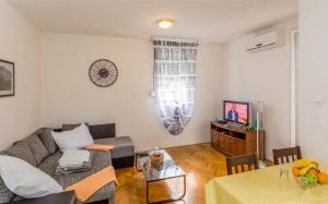 a living room with a couch and a table at Breki Apartman in Podstrana