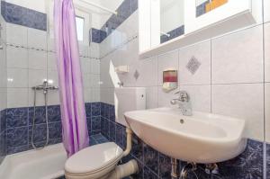 a bathroom with a sink and a toilet and a tub at Apartments Caric in Ivan Dolac +41 photos